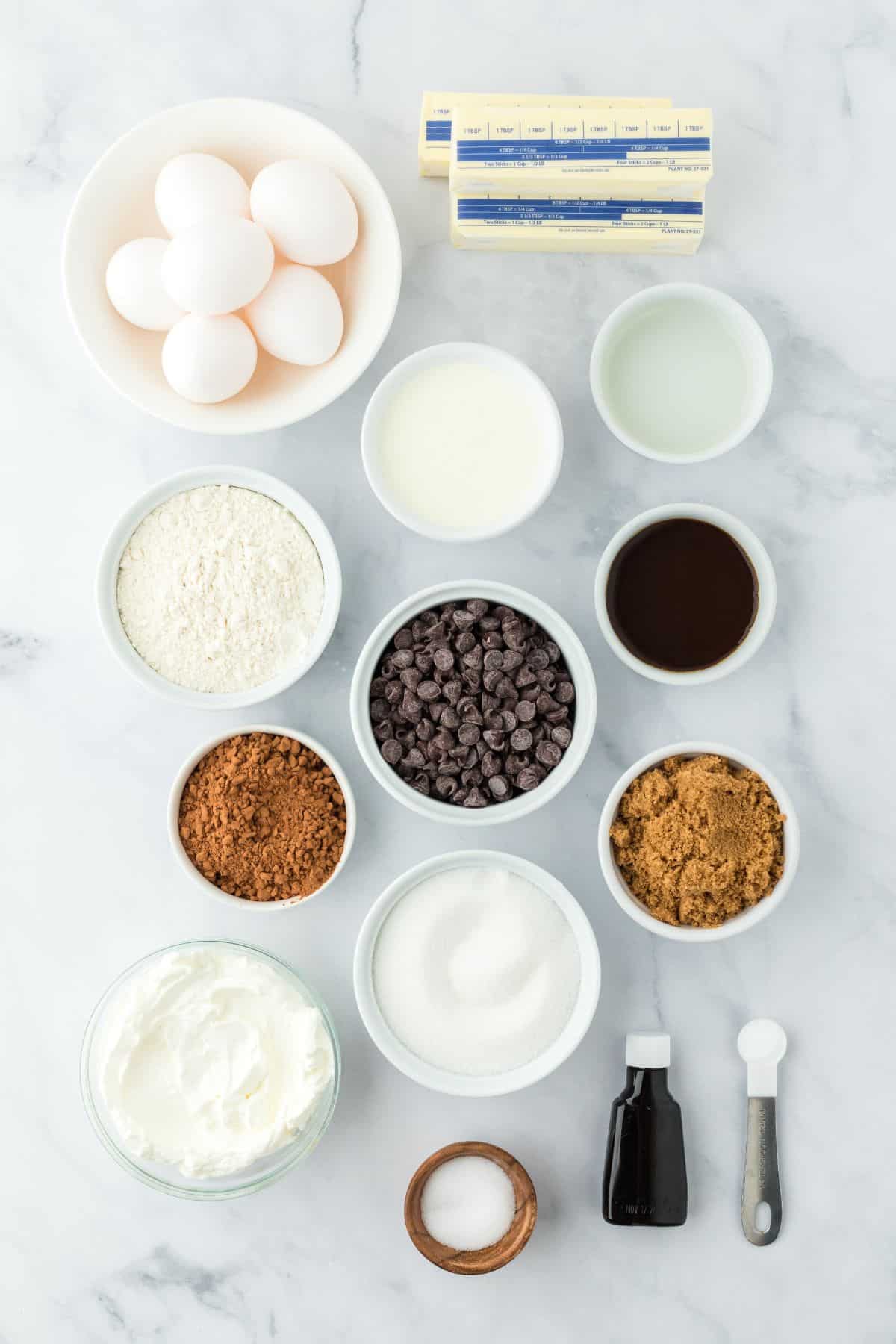 Overheat shot of ingredients for making chocolate pound cake in a marble surface before baking