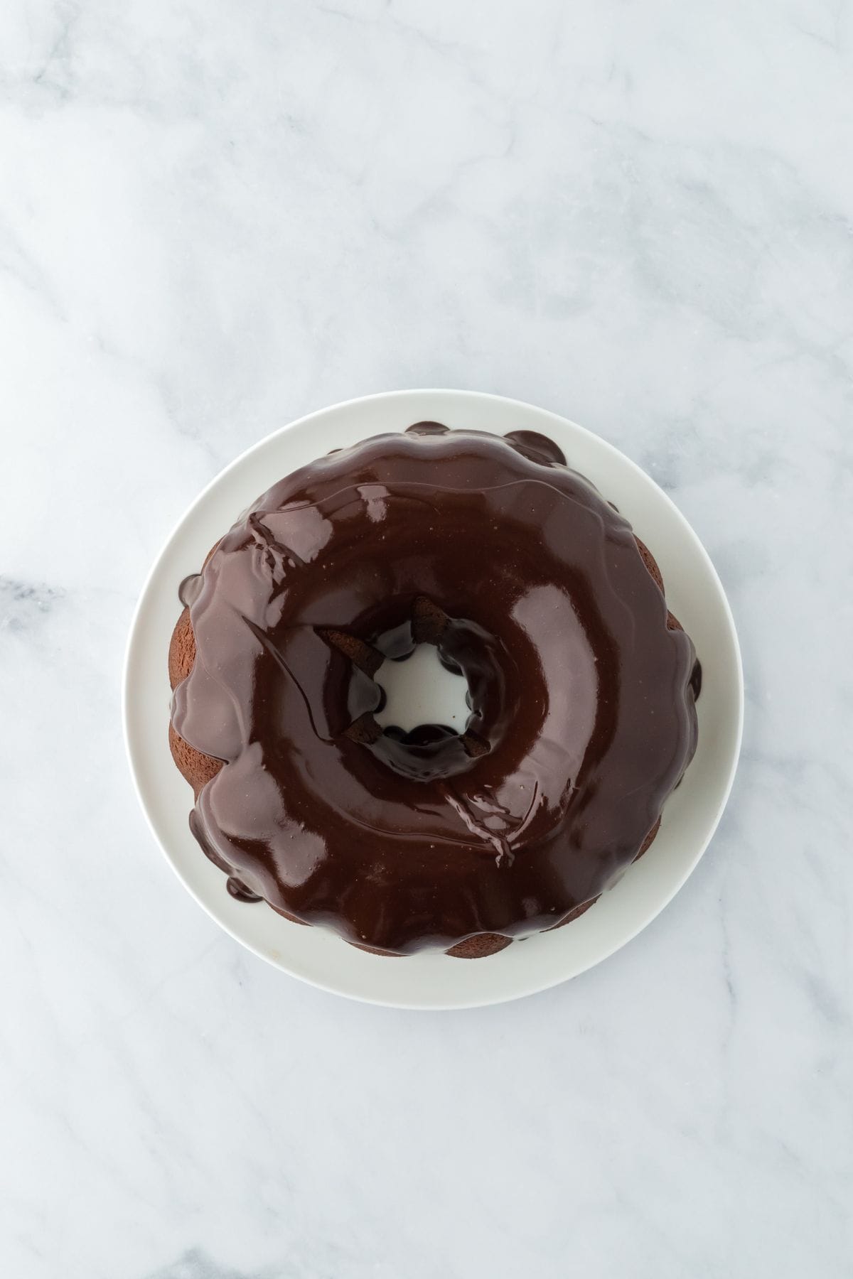 Overhead view of a chocolate pound cake with a glossy chocolate glaze covering the top