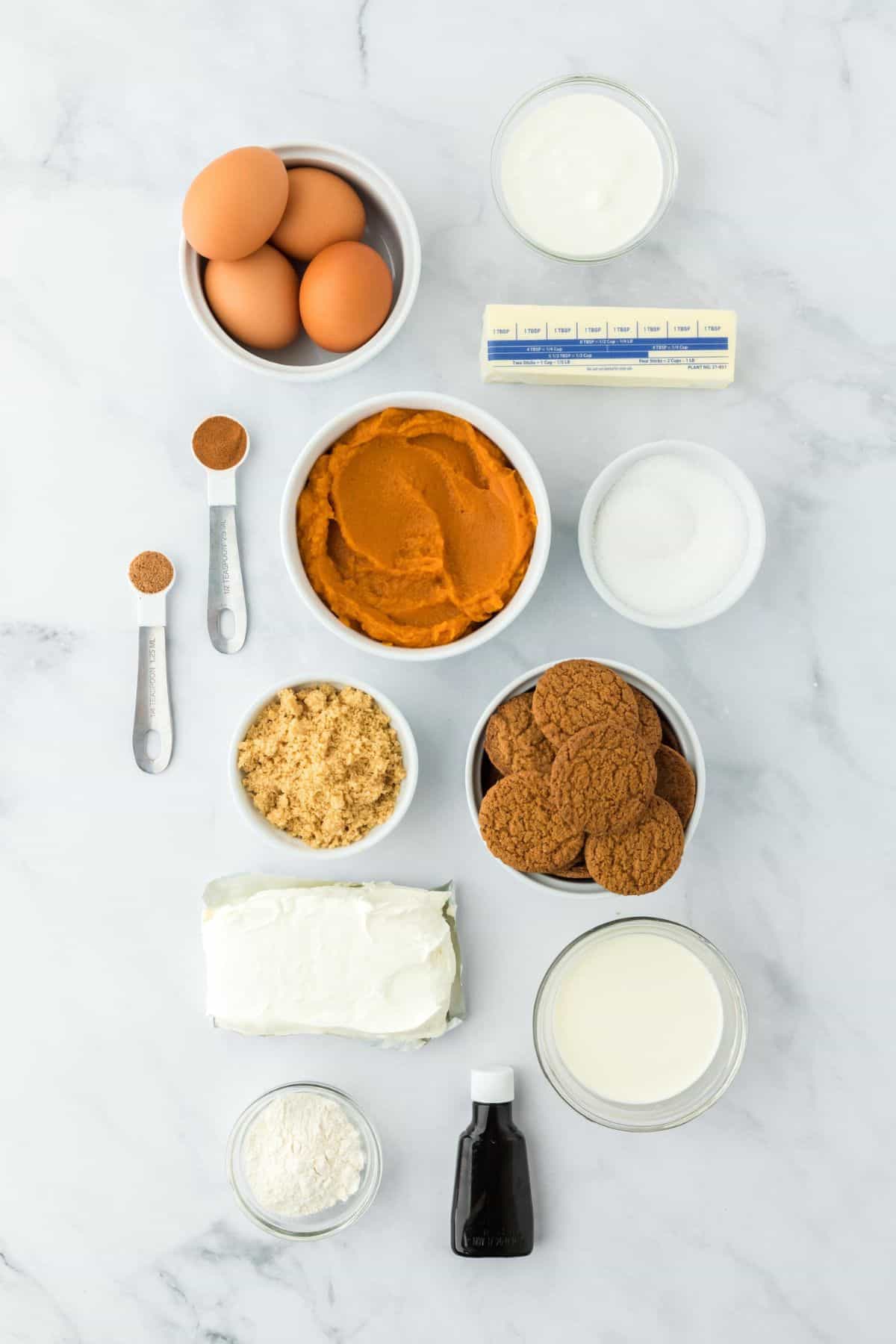 Overhead shot of ingredients to make pumpkin spice on a marble surface before mixing