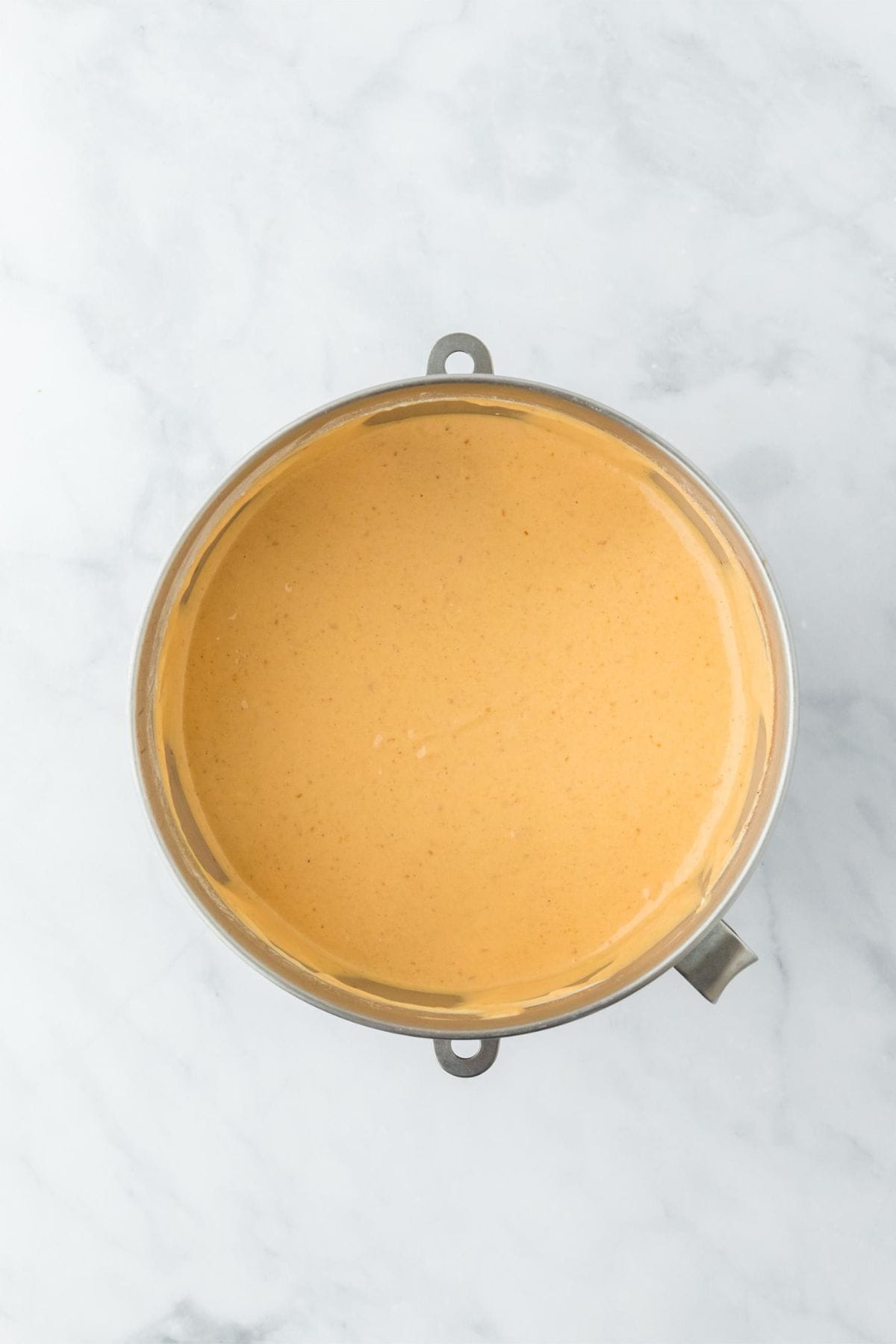 Smooth and blended pumpkin cheesecake filling in a mixing bowl