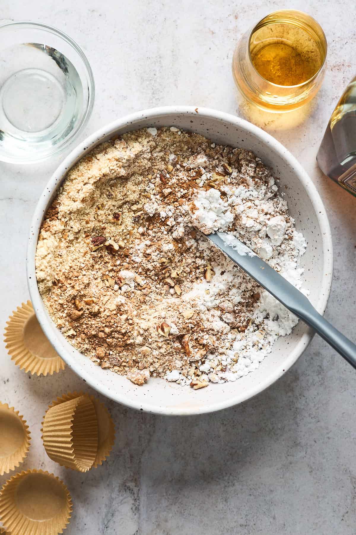 ground cookies, pecans and other ingredients to make candy in a white bowl