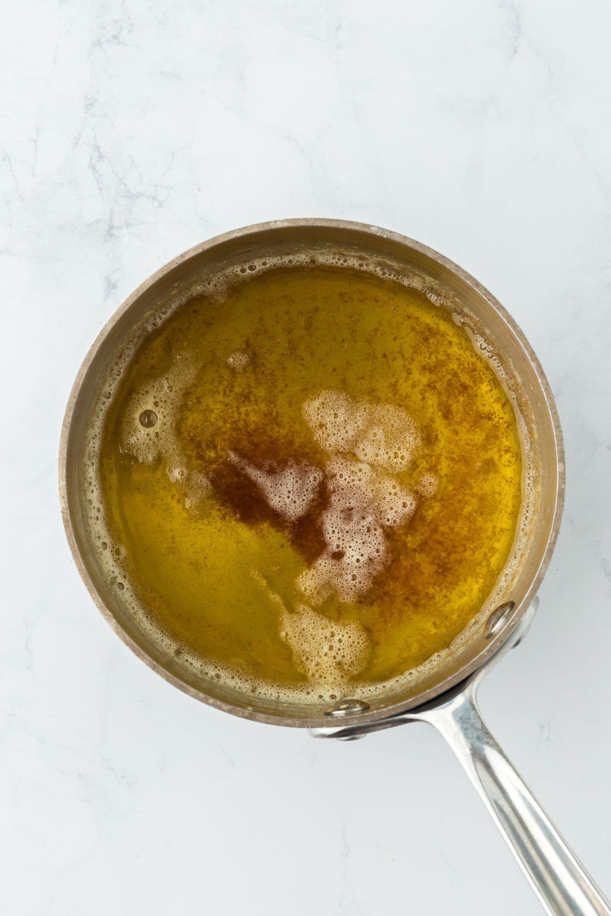 Melted butter with brown bits, showing it's been browned