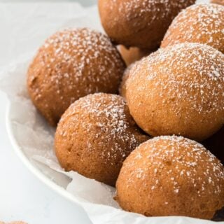 A plate of pound cake beignets dusted with powdered sugar