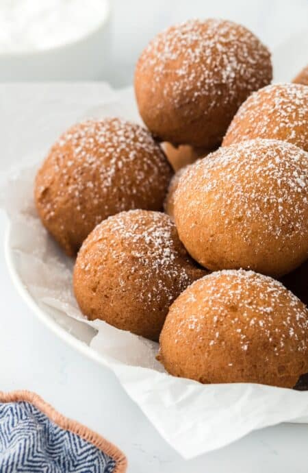 A plate of pound cake beignets dusted with powdered sugar