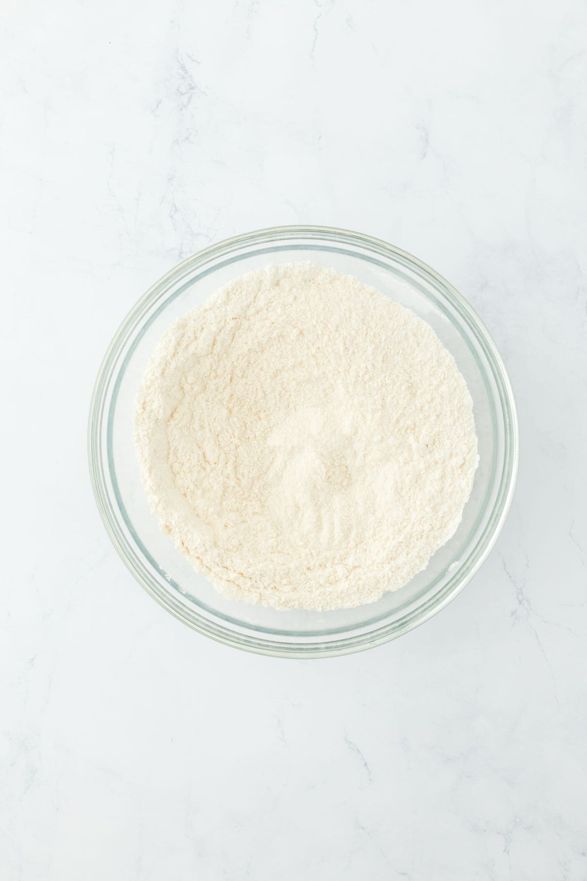 The dry ingredients mixed together into a uniform mixture in the same glass bowl