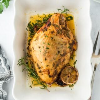 Roasted turkey breast in a white serving dish