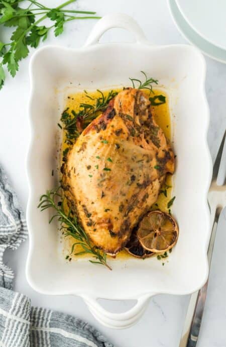 Roasted turkey breast in a white serving dish