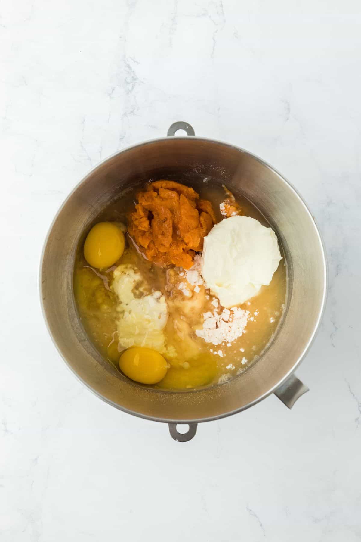 Ingredients for the sweet potato honey bun cake batter added to a mixing bowl