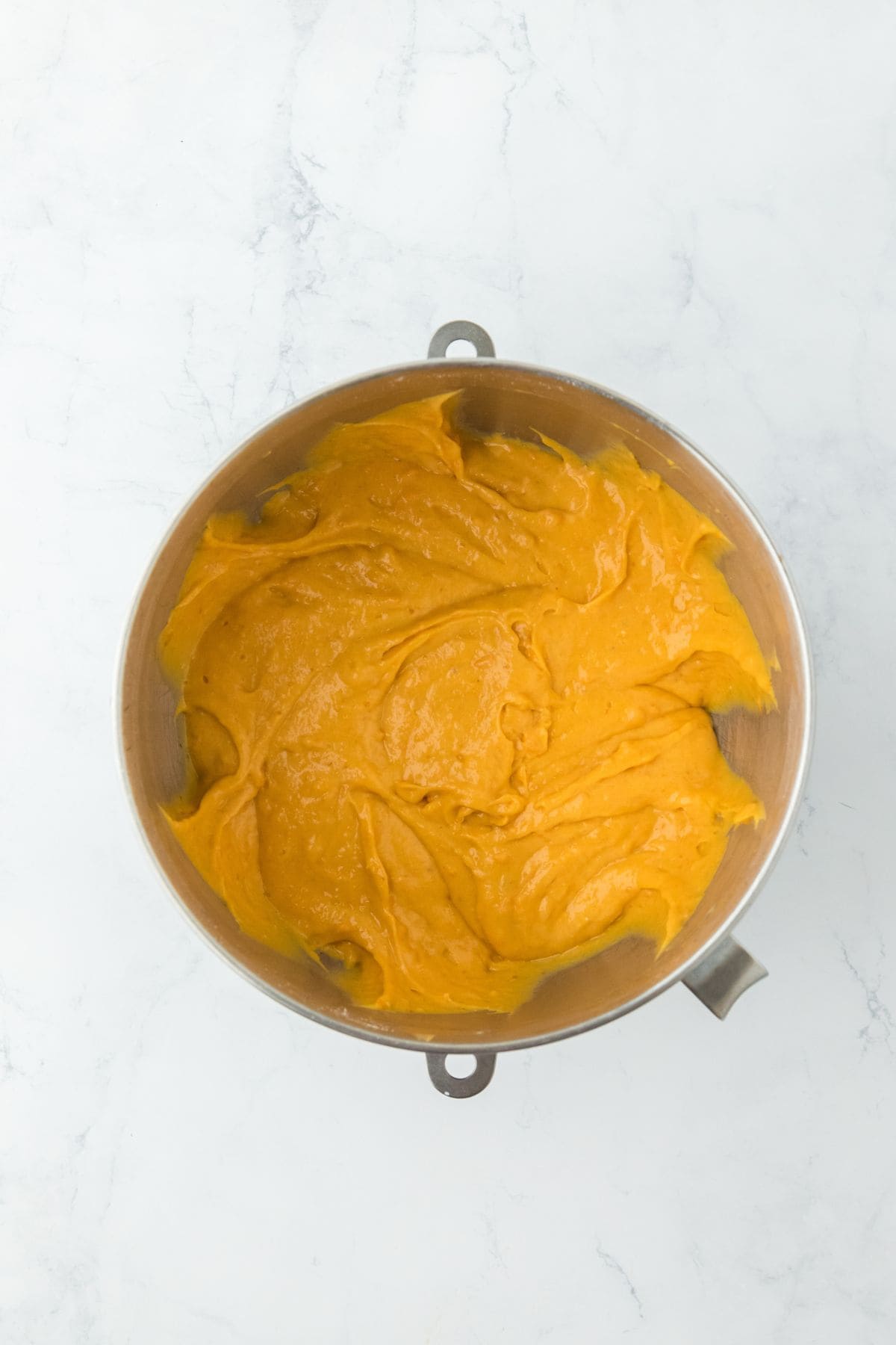 Mixing bowl filled with smooth, sweet potato cake batter