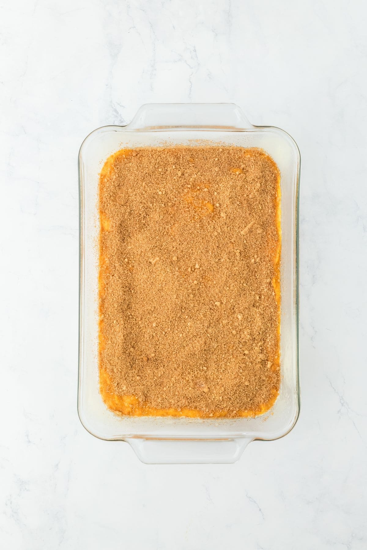 A layer of the spice swirl spread on top of the cake batter in a glass dish