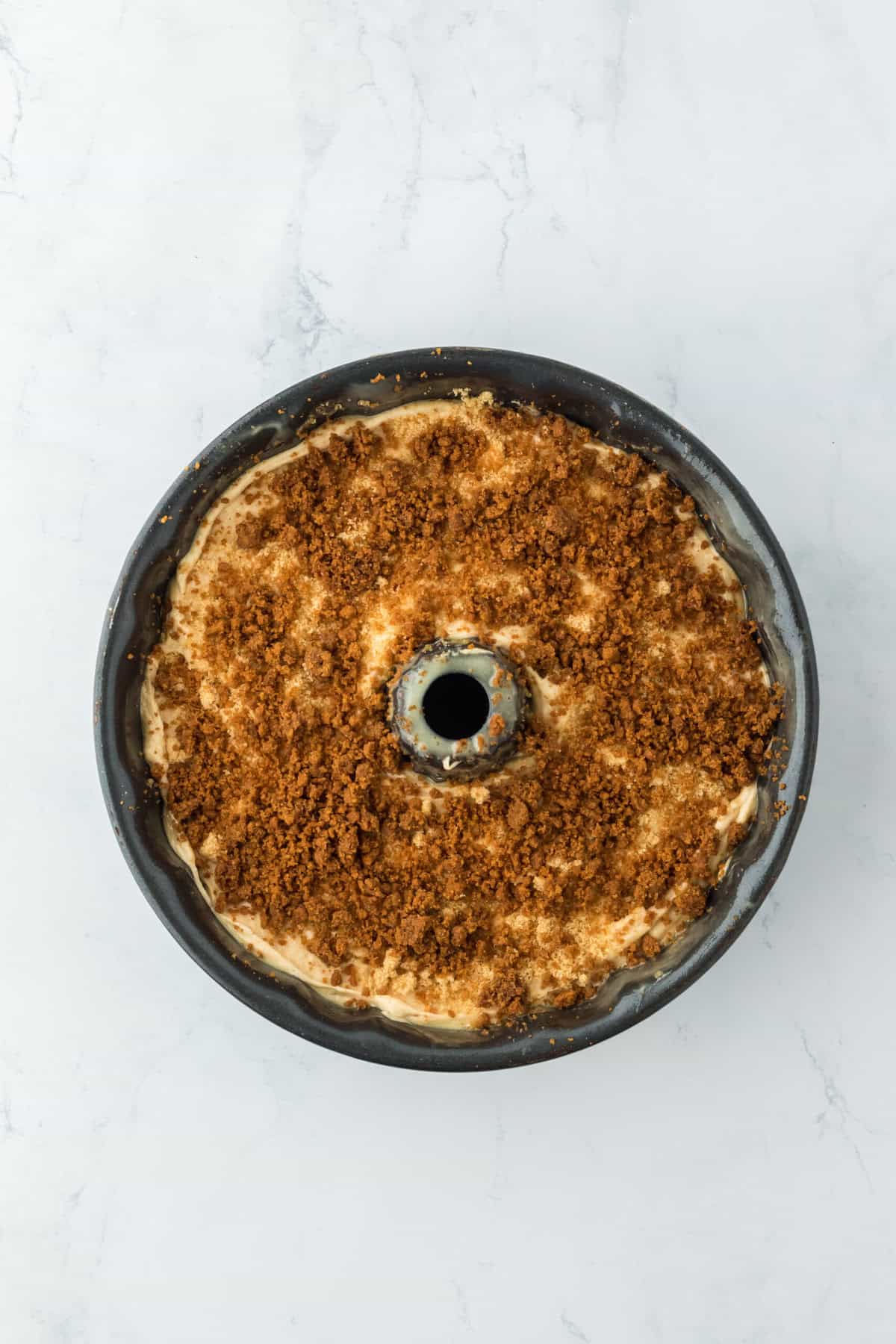 Crumbled biscoff on top of cake batter before baking