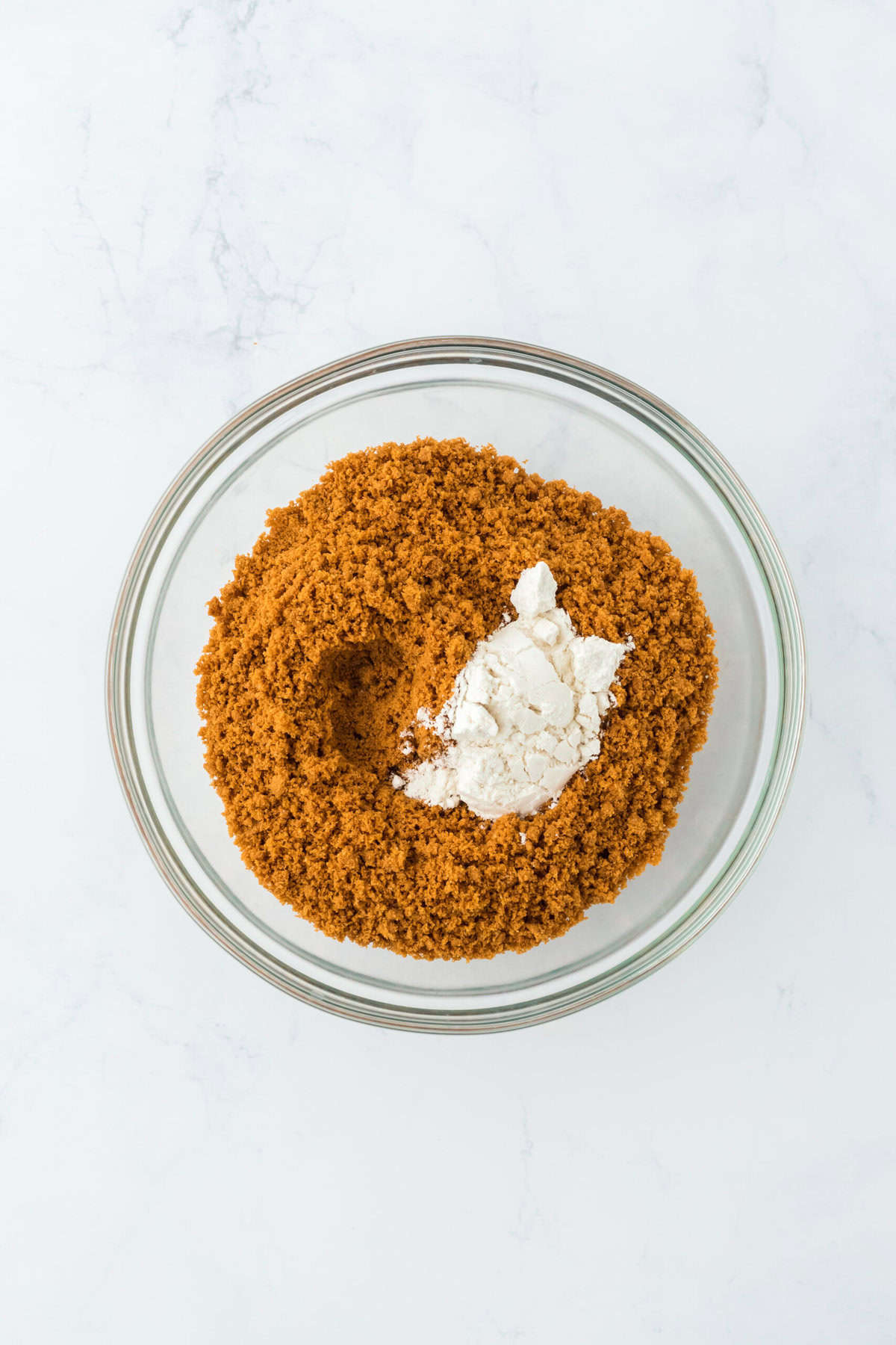 biscoff cookies crushed in a bowl with flour