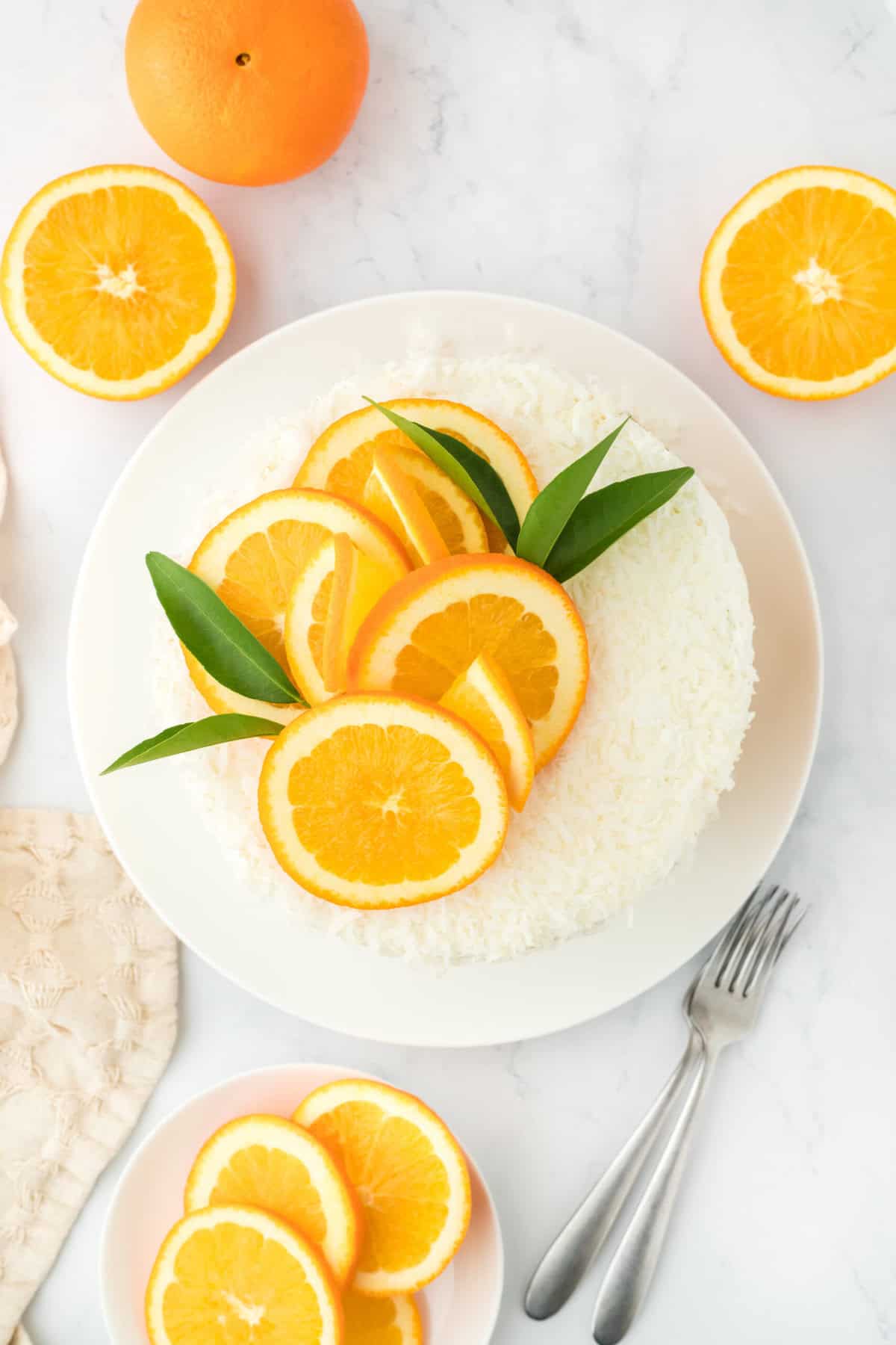 Completed orange coconut cake with orange slices on top ready to enjoy