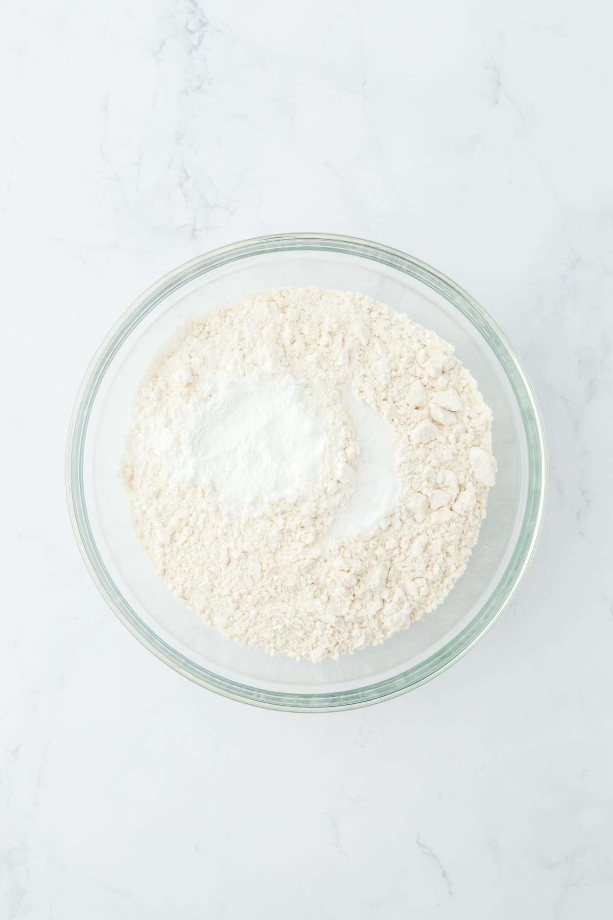 Dry ingredients added to a glass bowl