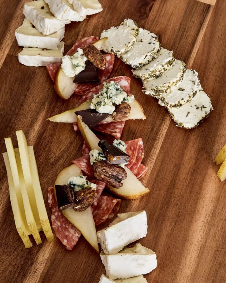 Bold and blue charcuterie bites on a wooden board