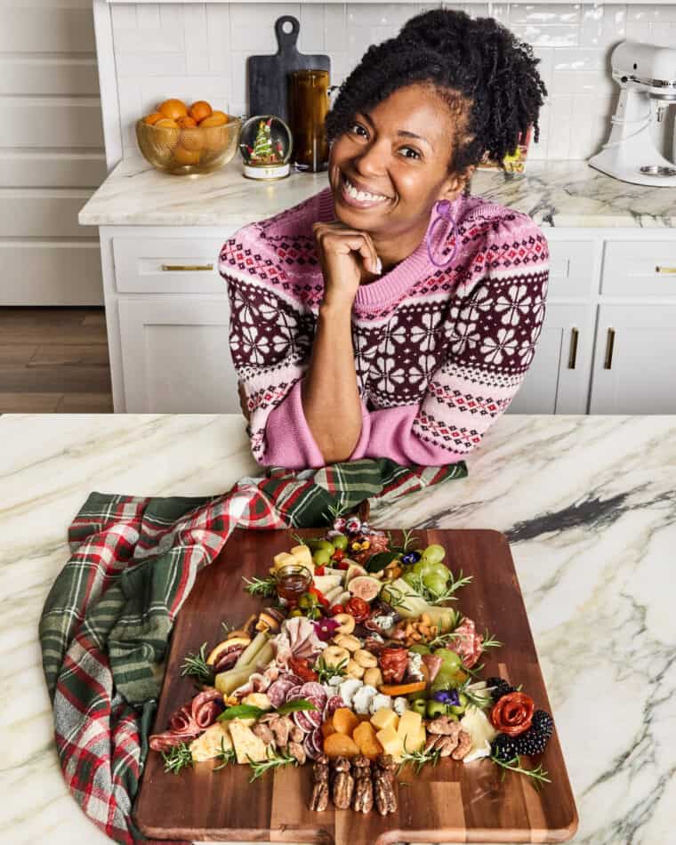 Jocelyn Delk Adams next to her finished Christmas Tree Charcuterie board