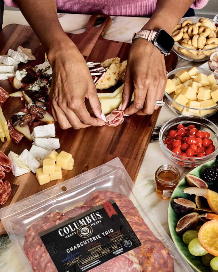 Jocelyn Delk Adams hands building a Christmas tree charcuterie board to serve