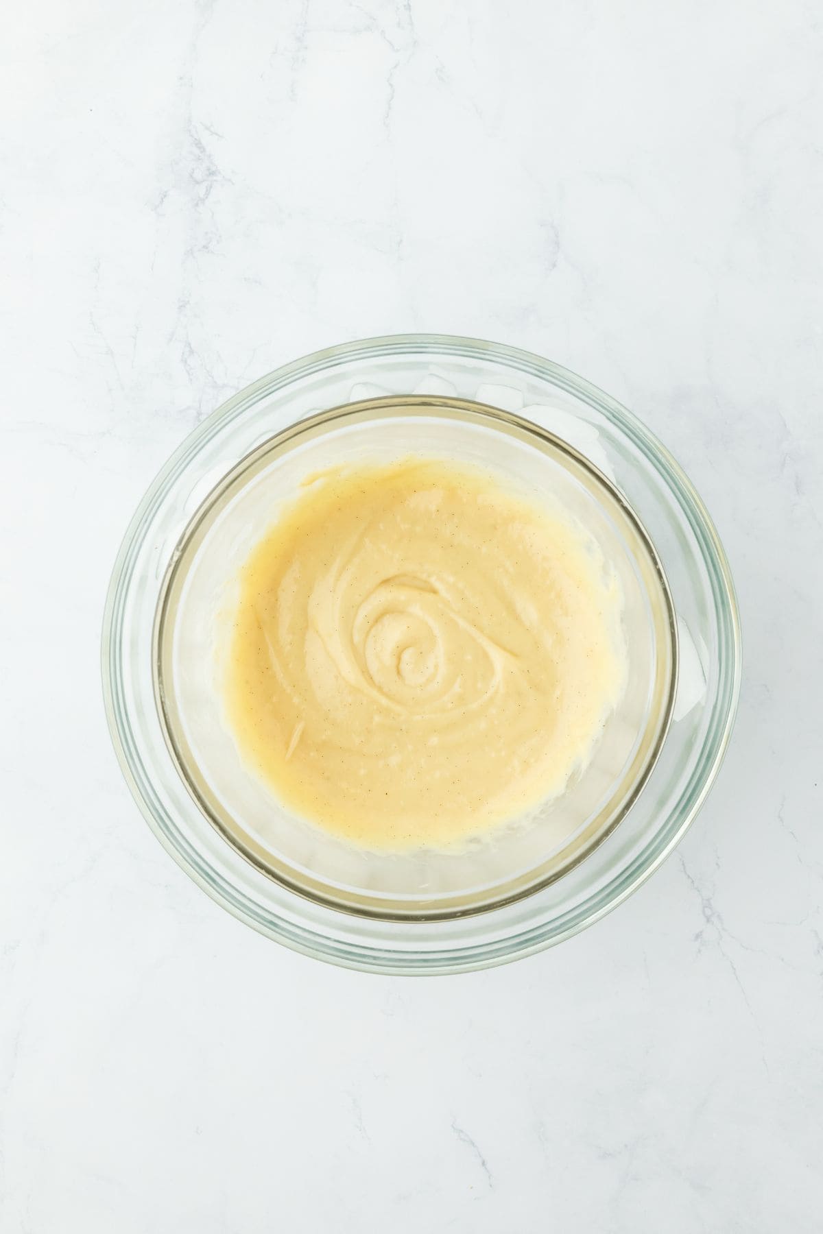 Smooth, stirred custard in a glass bowl