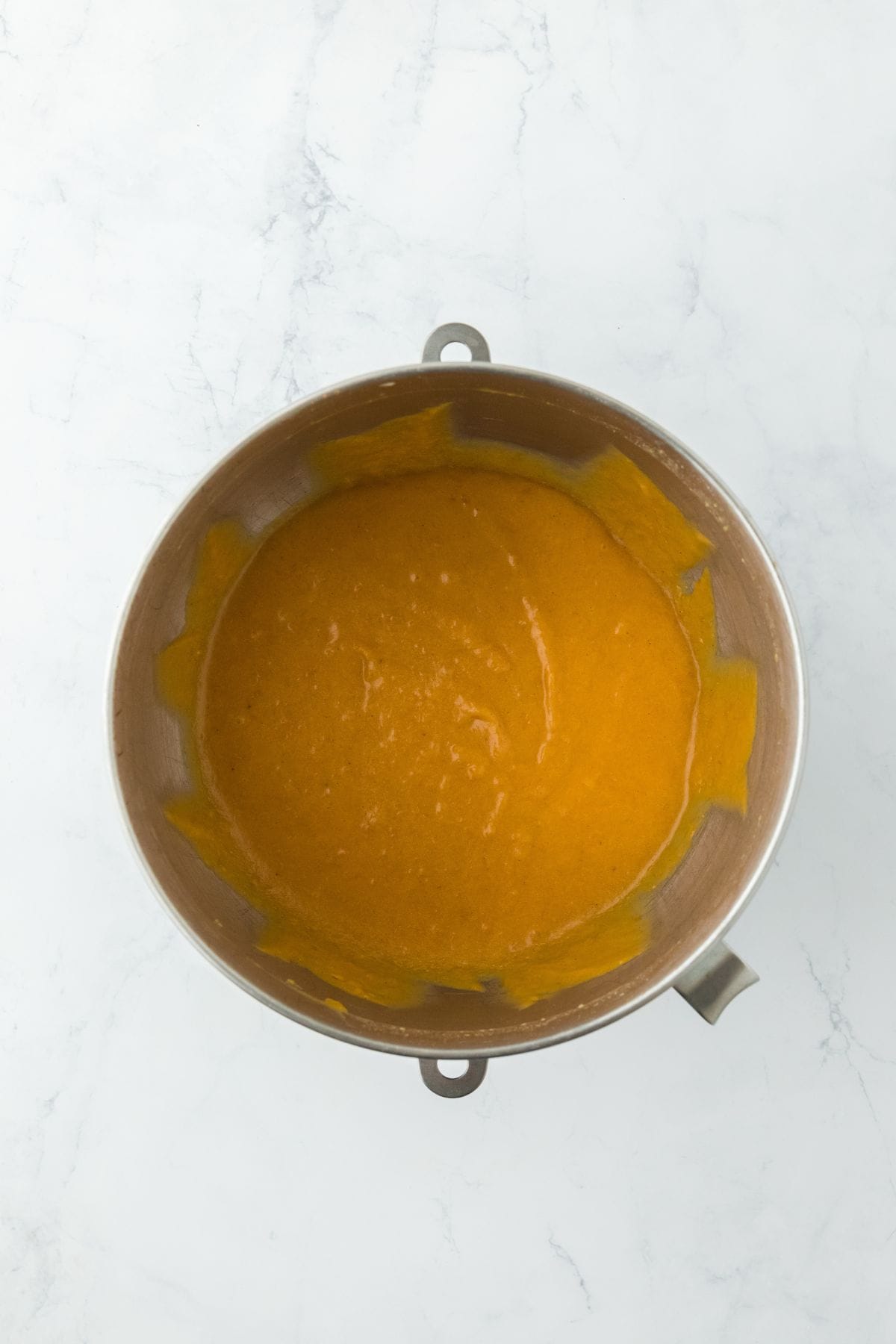 A smooth, combined sweet potato pie filling in a mixing bowl