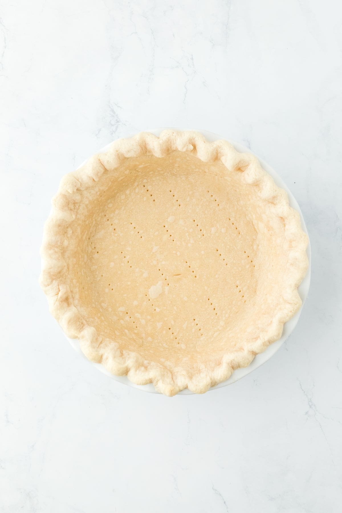 A fully prebaked pie crust with golden edges, ready to be filled