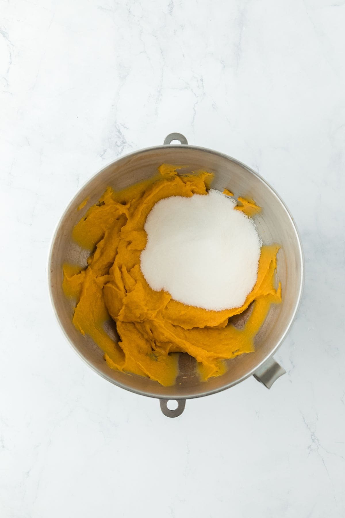 Sweet potatoes blended with sugar in a mixing bowl