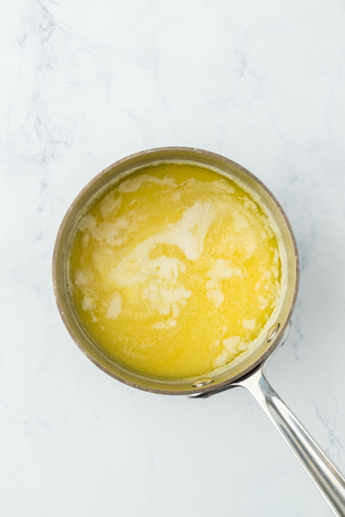 Melted butter mixture in a saucepan, partially blended