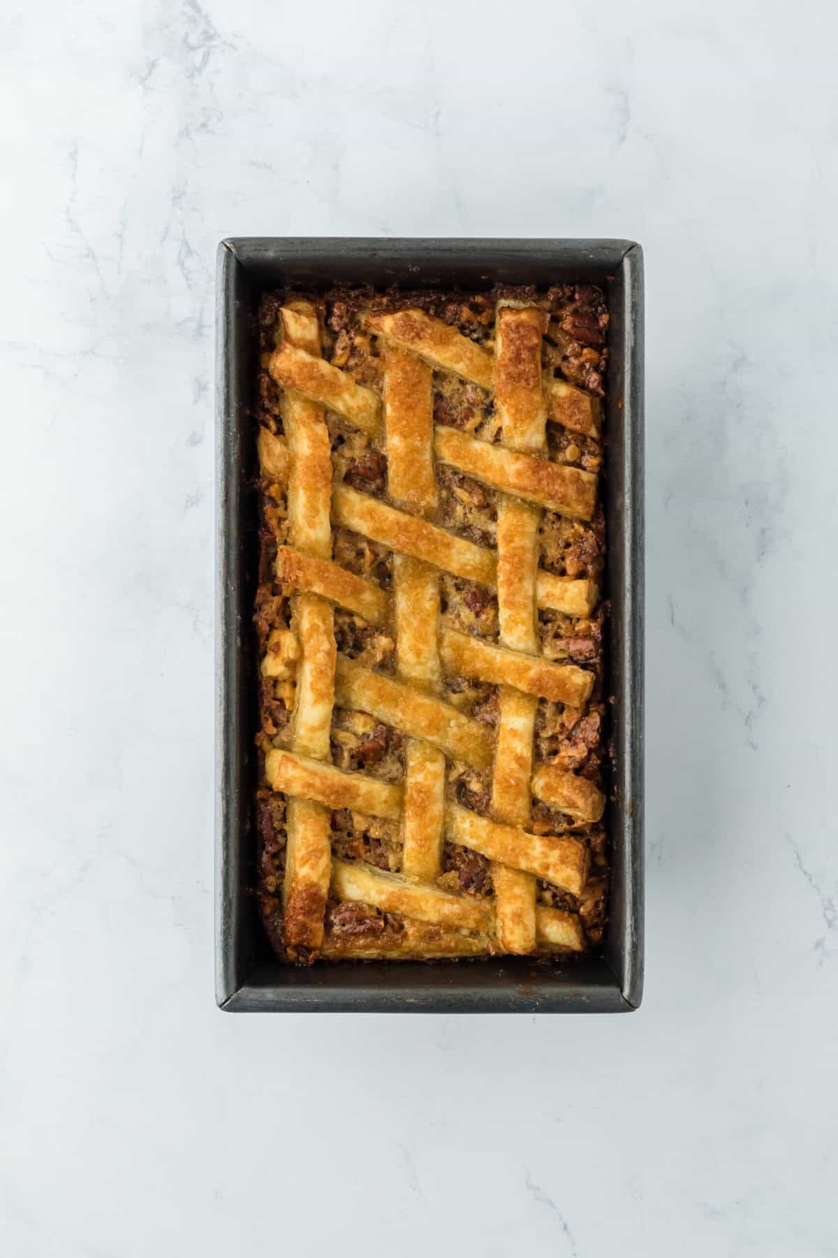 Pecan cobbler pie finished out of the oven on white countertop