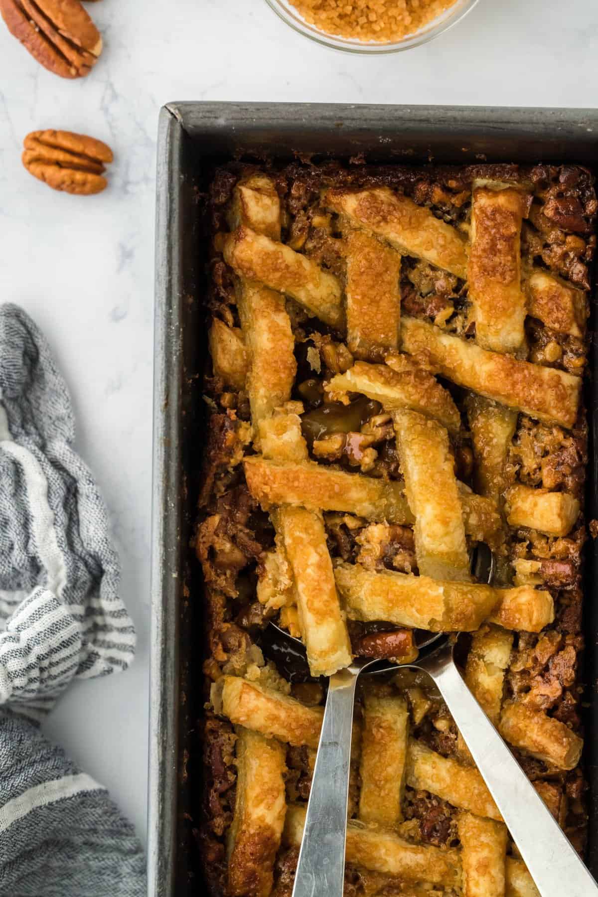 Pecan pie cobbler being dug into with spoons to serve up