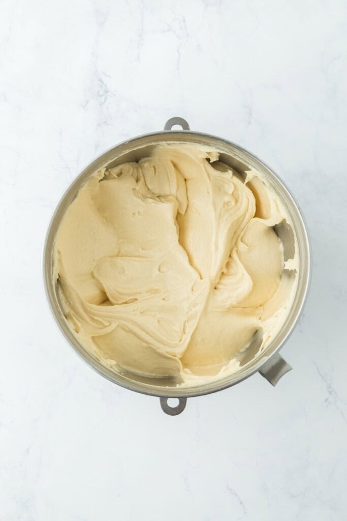 Finished easy pound cake batter in a stand mixer bowl on white countertop