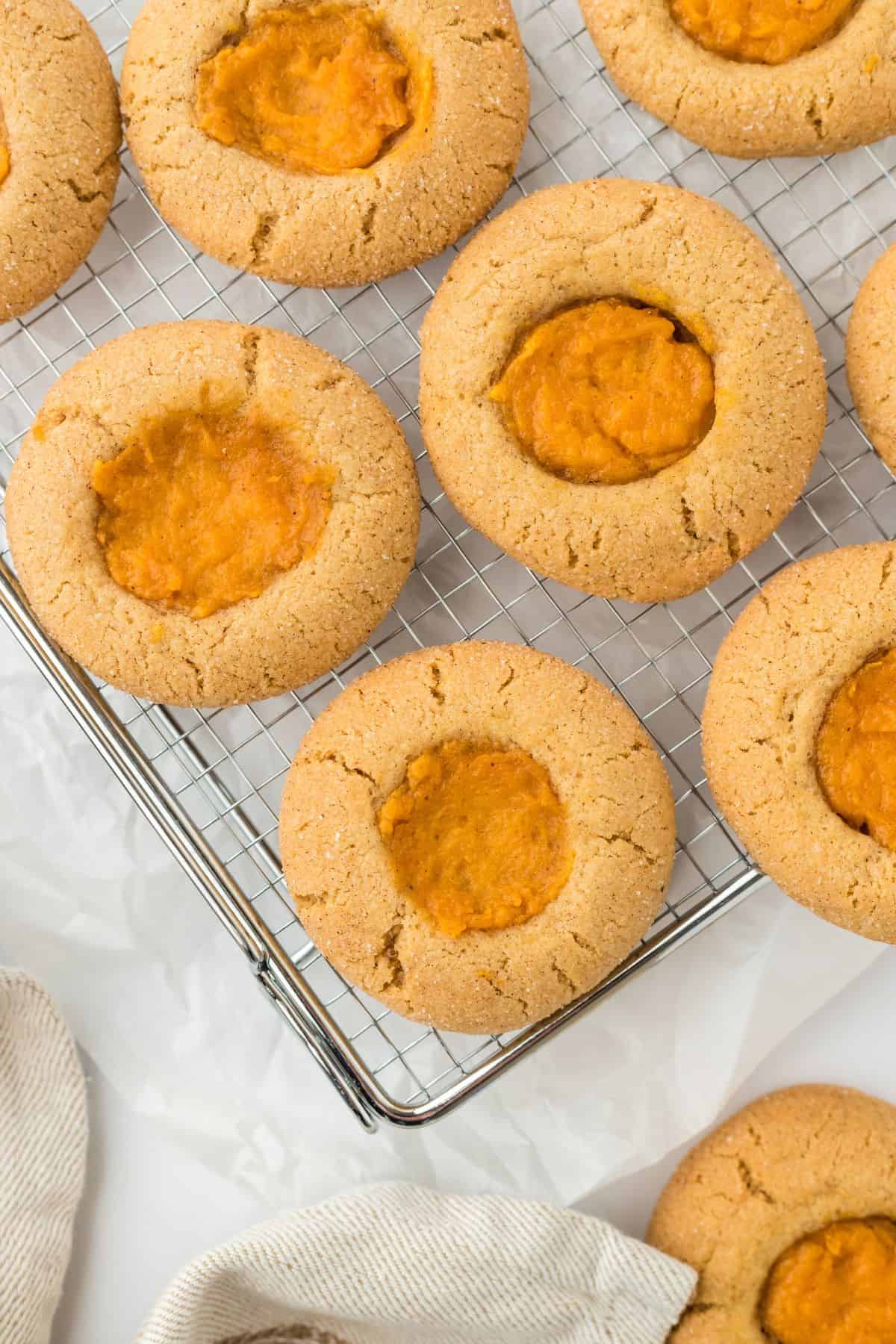 Overhead shot of several sweet potato pie cookies on a cooling rack