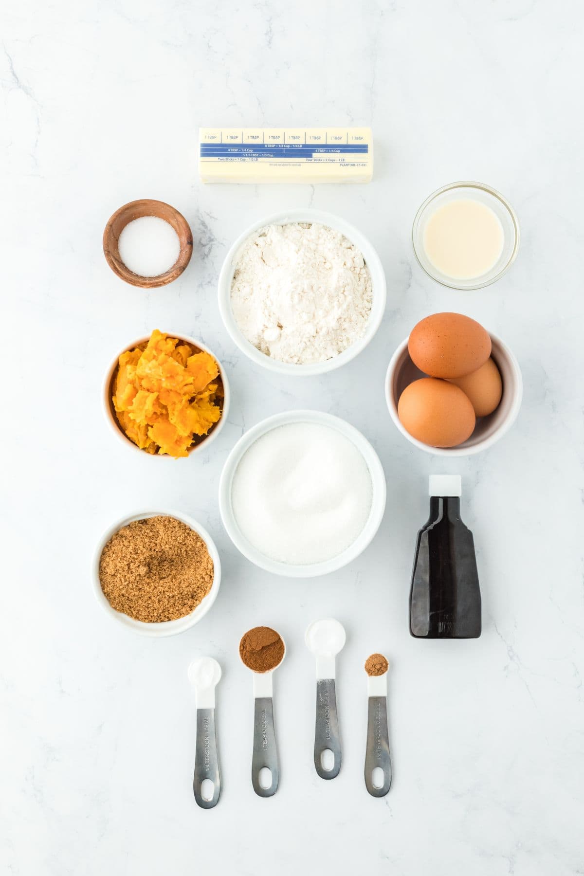 Overhead shot of ingredients to make sweet potato pie cookies on a white surface before mixing