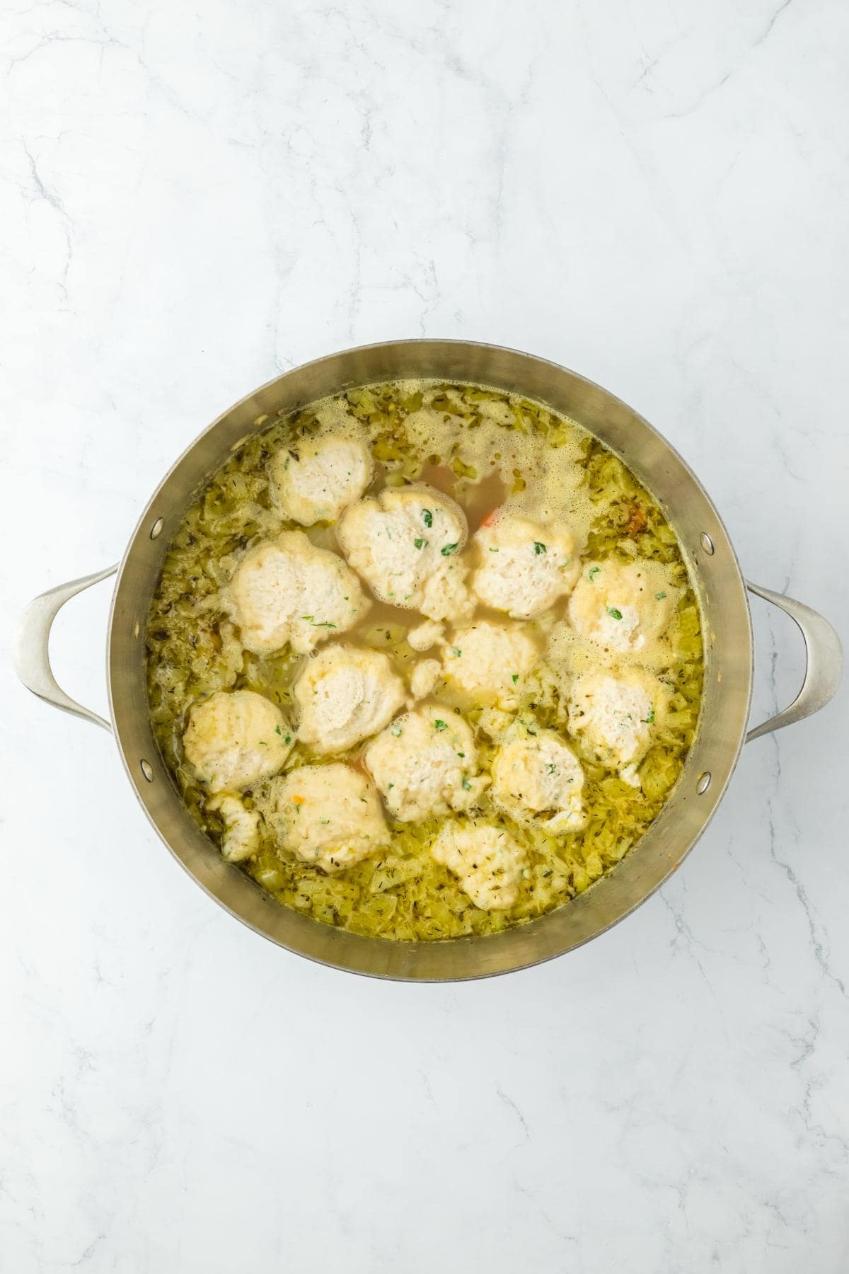 Dumplings dropped into the soup, starting to cook