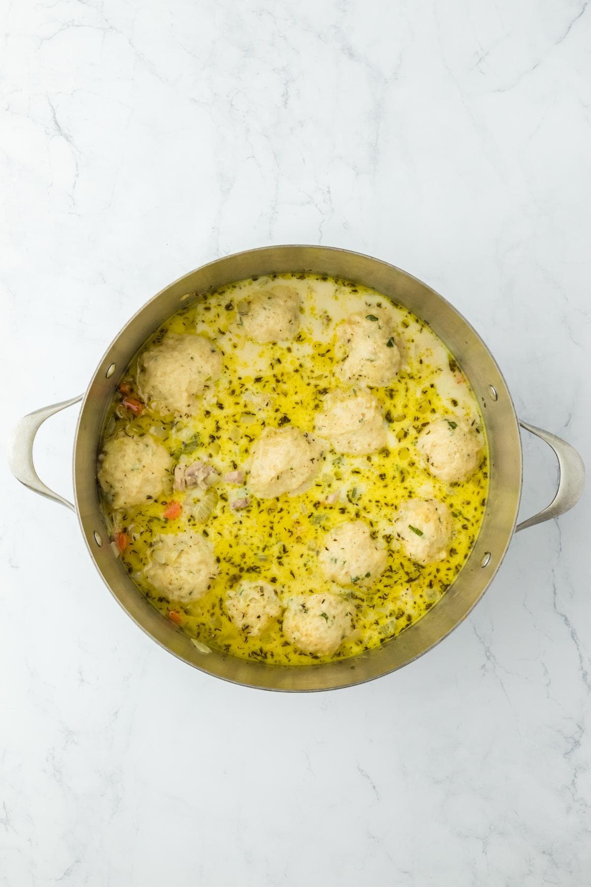 Final pot of chicken and dumpling soup with a creamy broth and fluffy dumplings