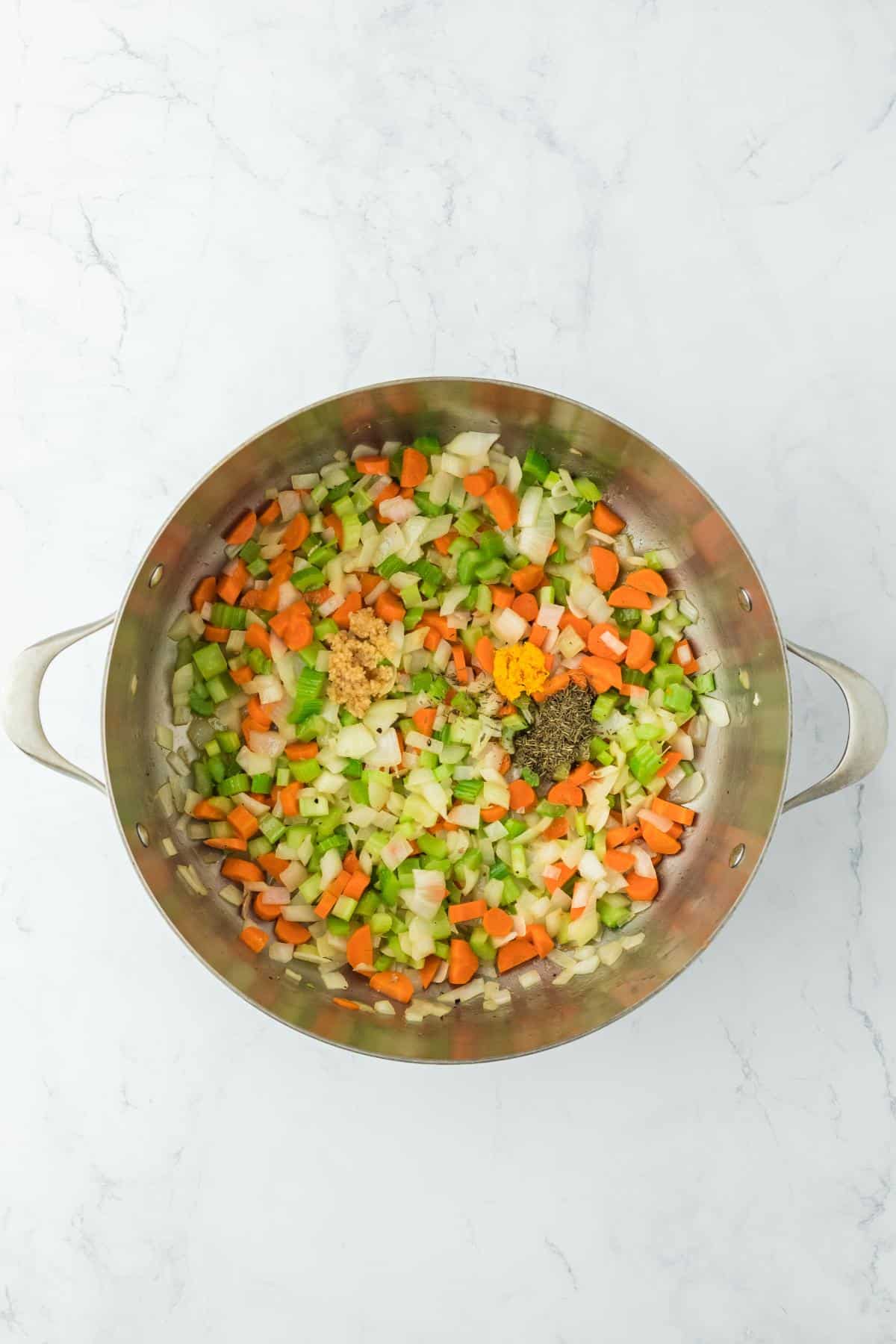 Mixed vegetables in the pot with added herbs and seasonings