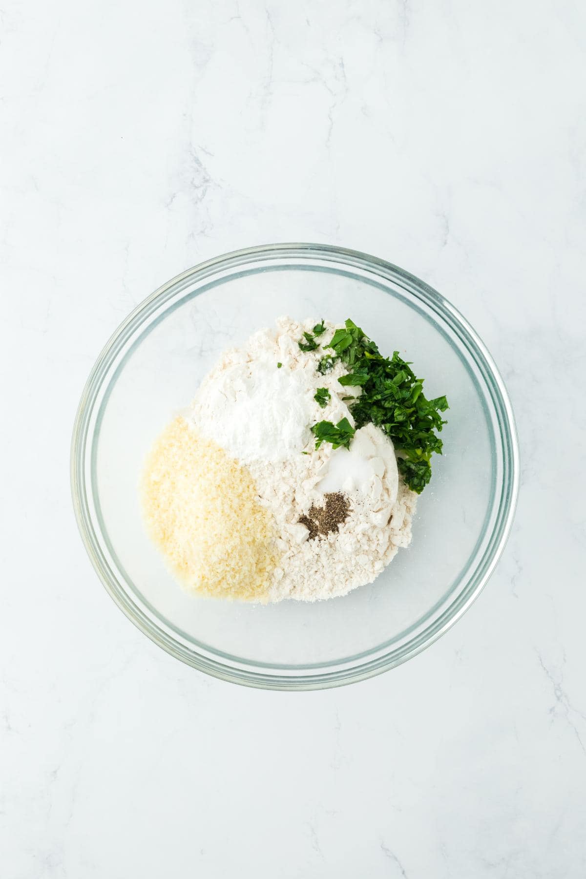 Ingredients for dumplings in a mixing bowl, not yet combined