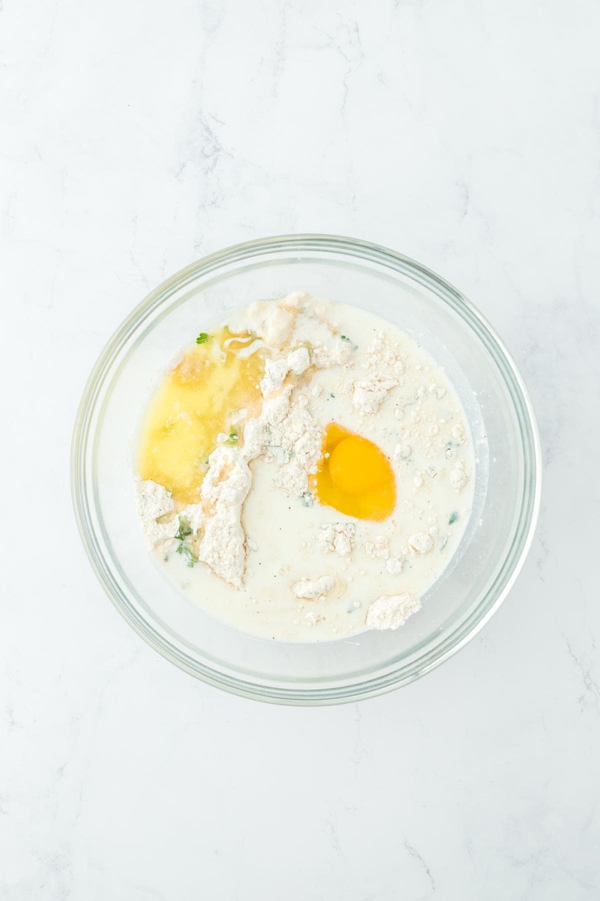 Dumpling ingredients with egg and milk added, ready to mix