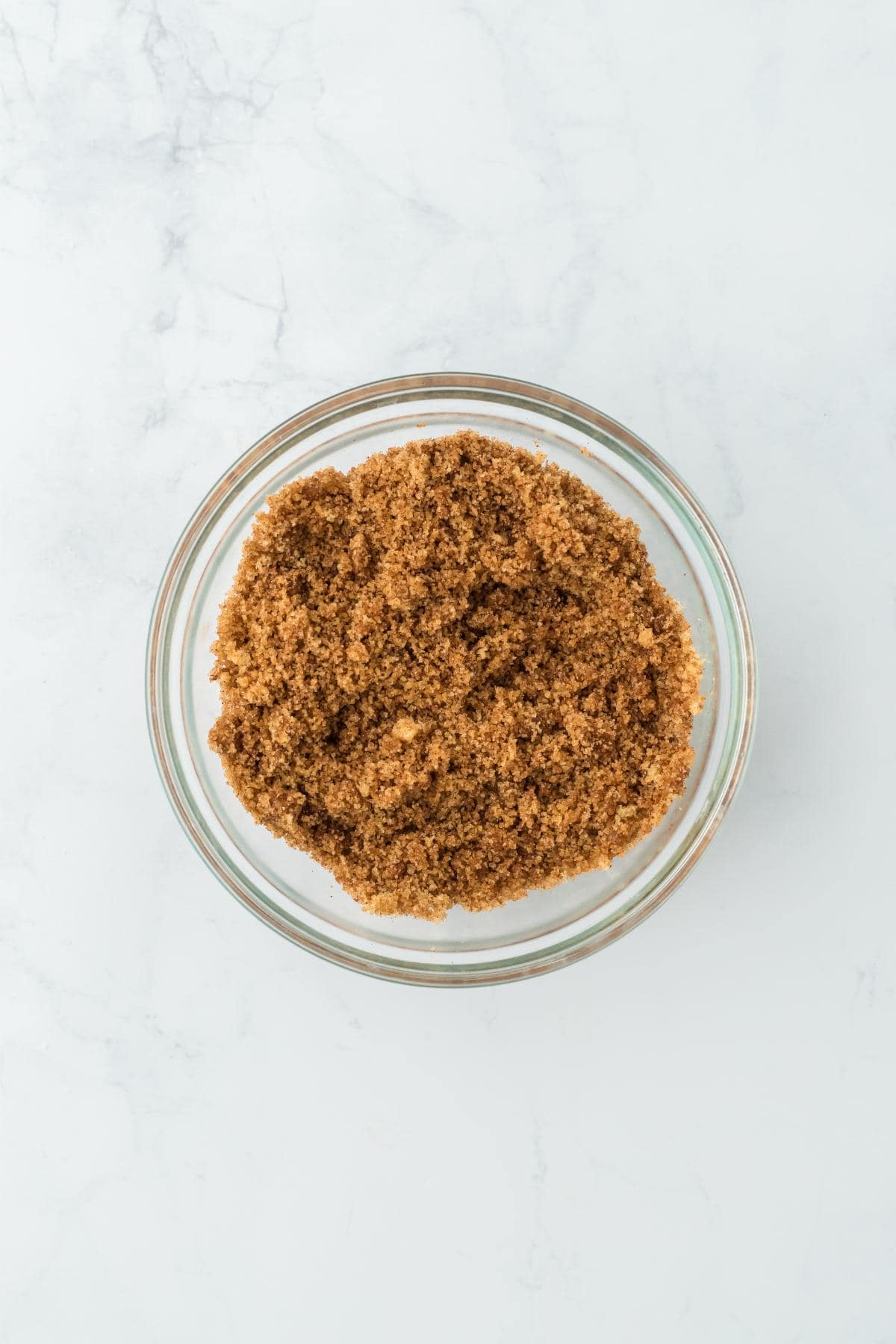 A glass bowl with the brown sugar and cinnamon fully mixed together