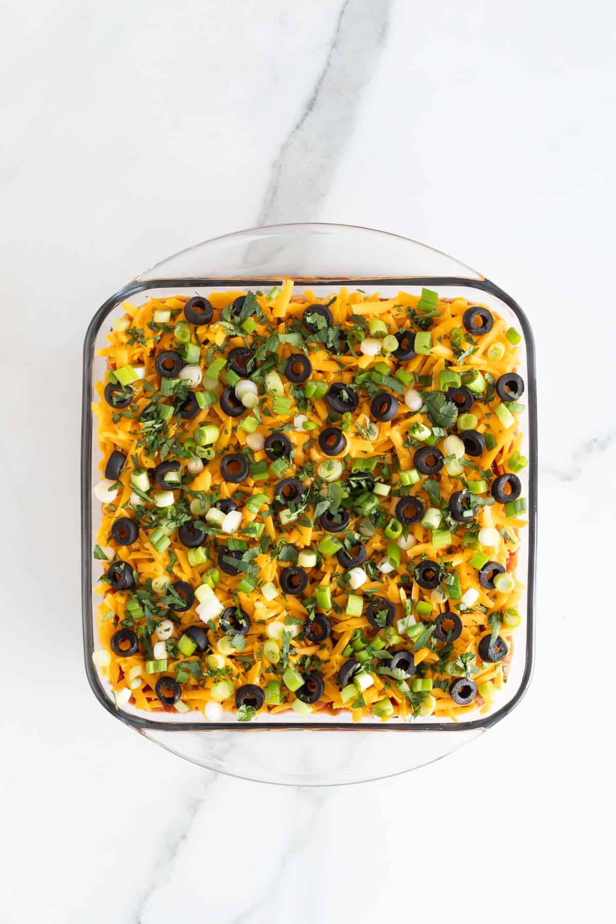 Finished 7 layer dip in glass dish ready to serve