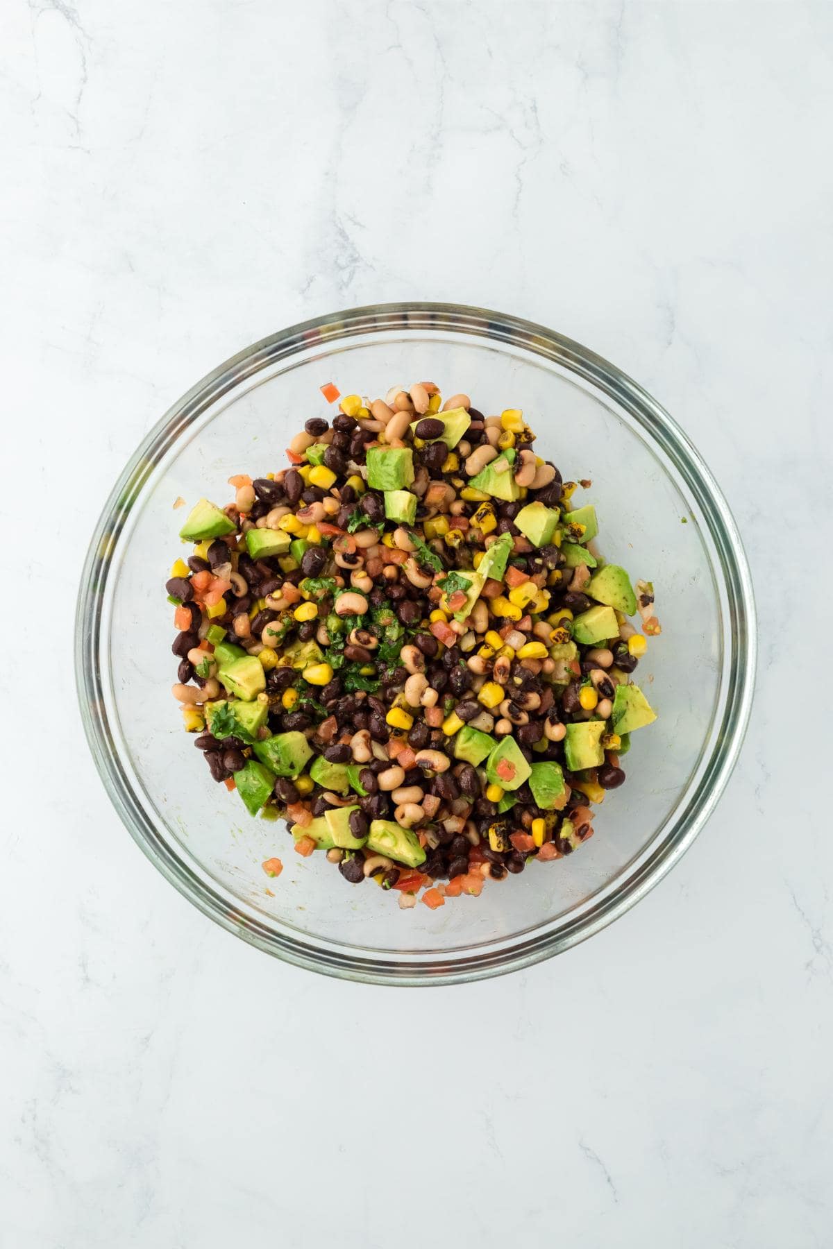 A glass bowl with the ingredients fully mixed together