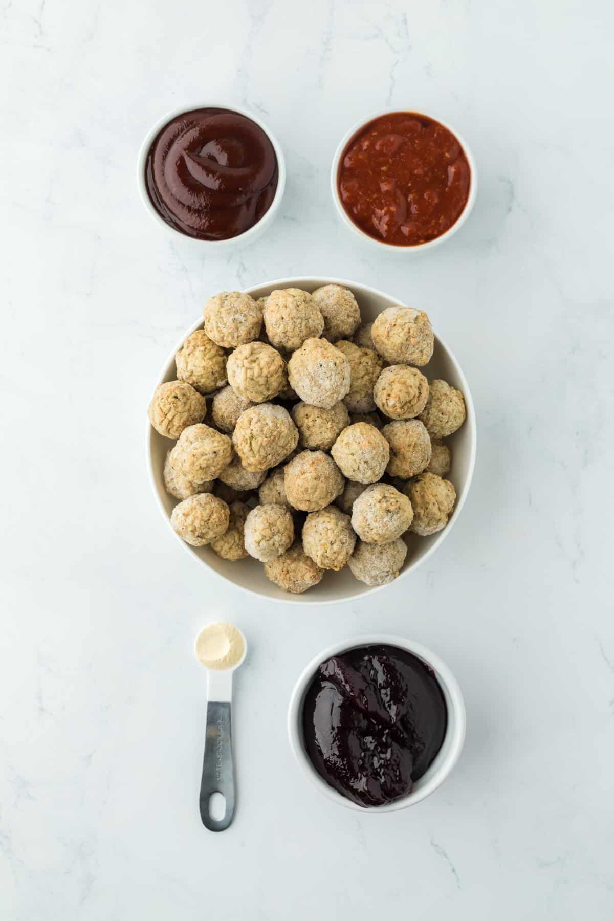 Overhead shot of ingredients for making grape jelly meatballs on a marble surface before cooking