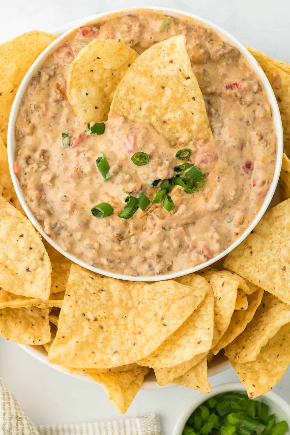 Two chips in a rotel cheese dip recipe ready to enjoy