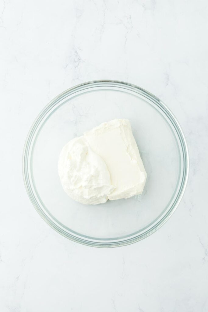 Glass bowl with cream cheese and sour cream before mixing