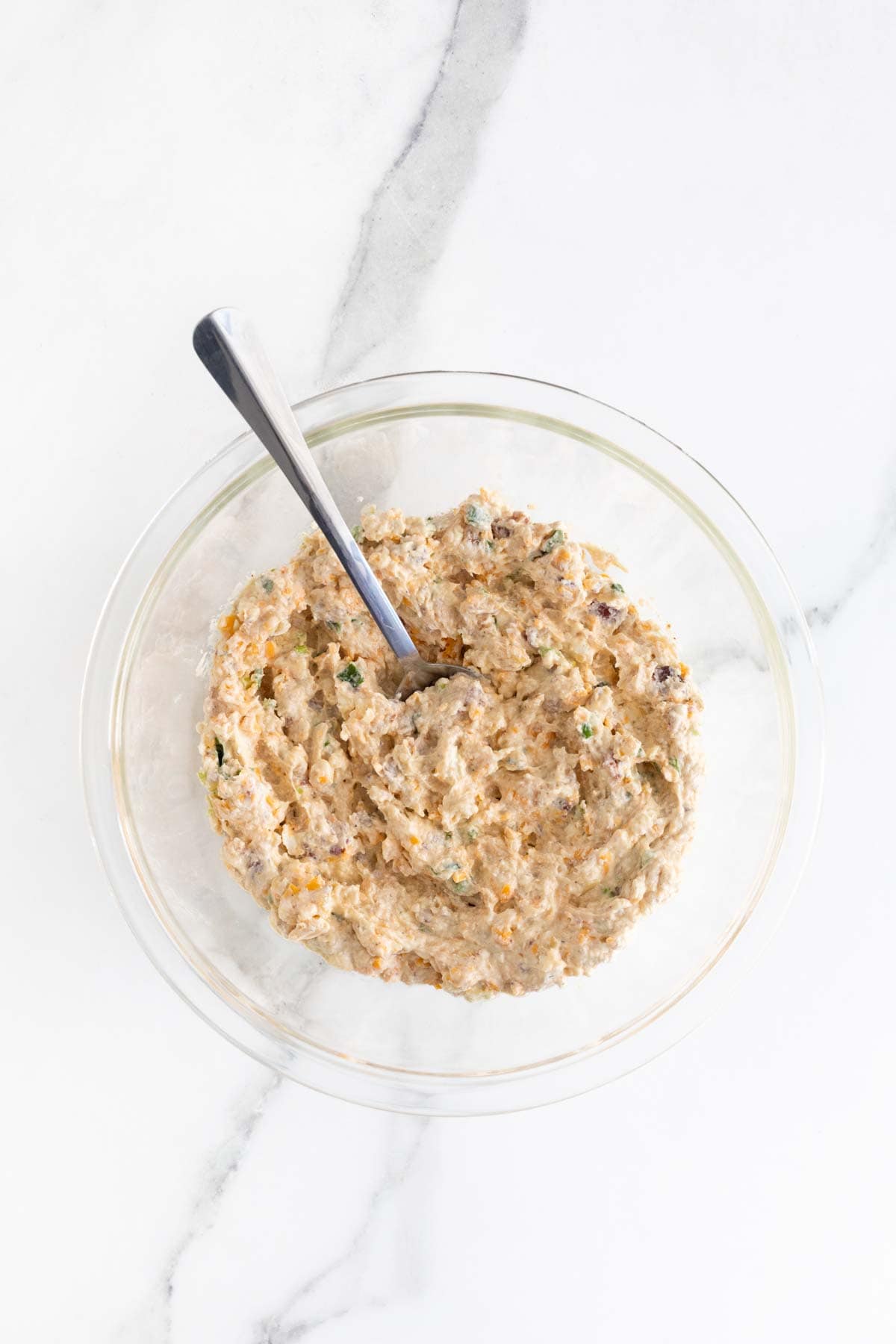 The dip ingredients combined into a creamy mixture, displayed in a glass mixing bowl