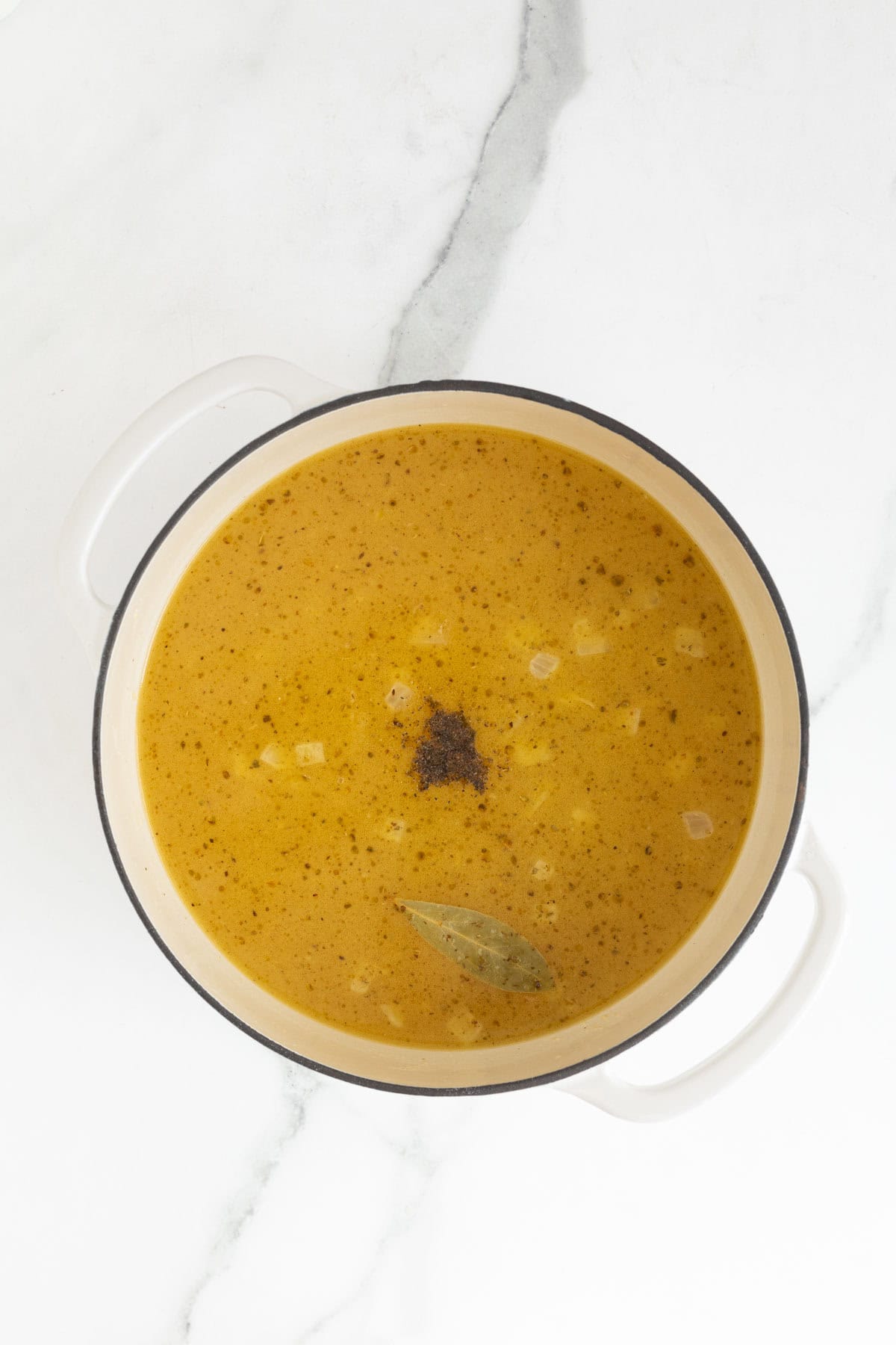 A simmering soup or broth inside the pot