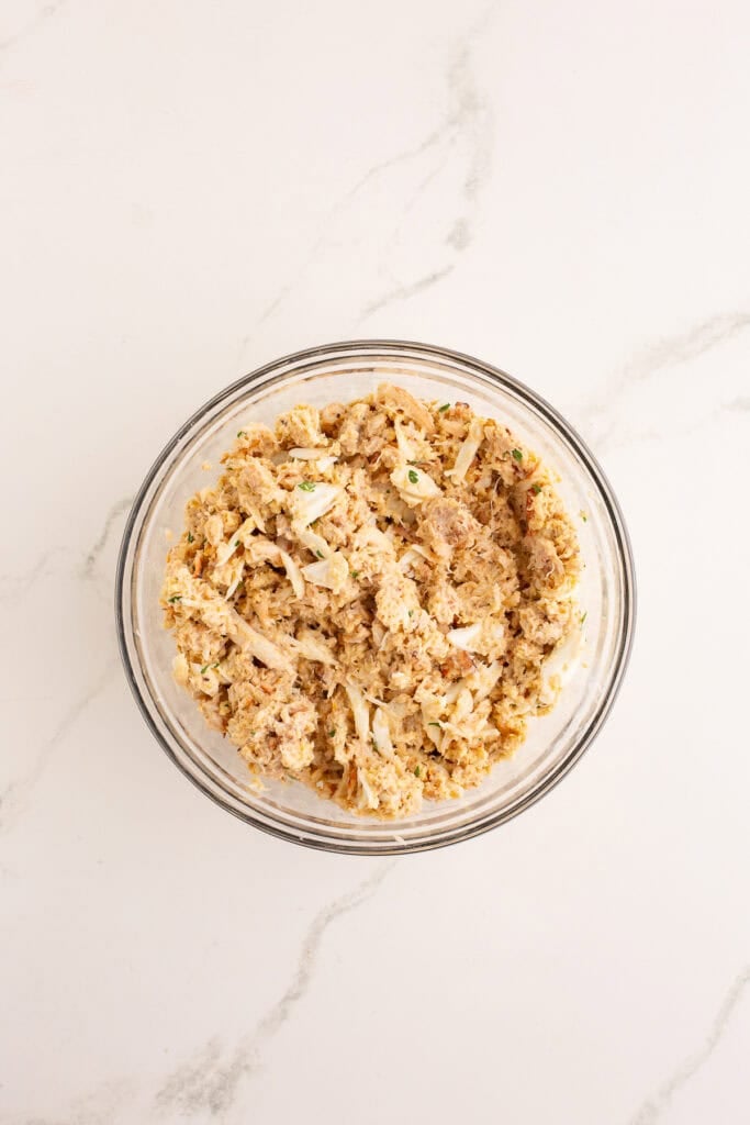 Completed crab cake recipe mixture in glass bowl
