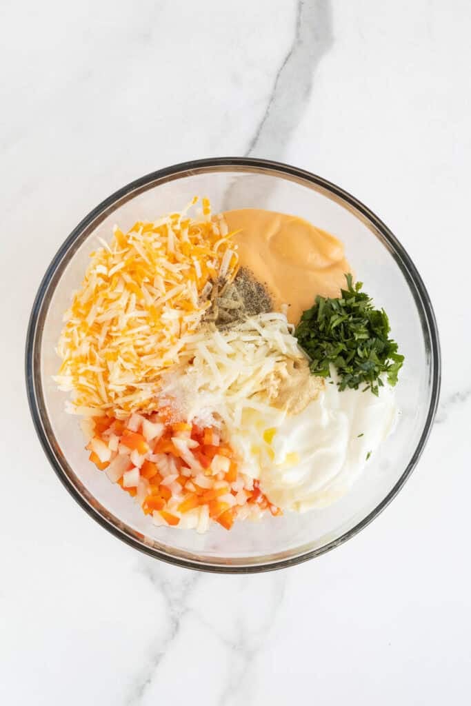 Ingredients for hashbrown casserole in a mixing bowl