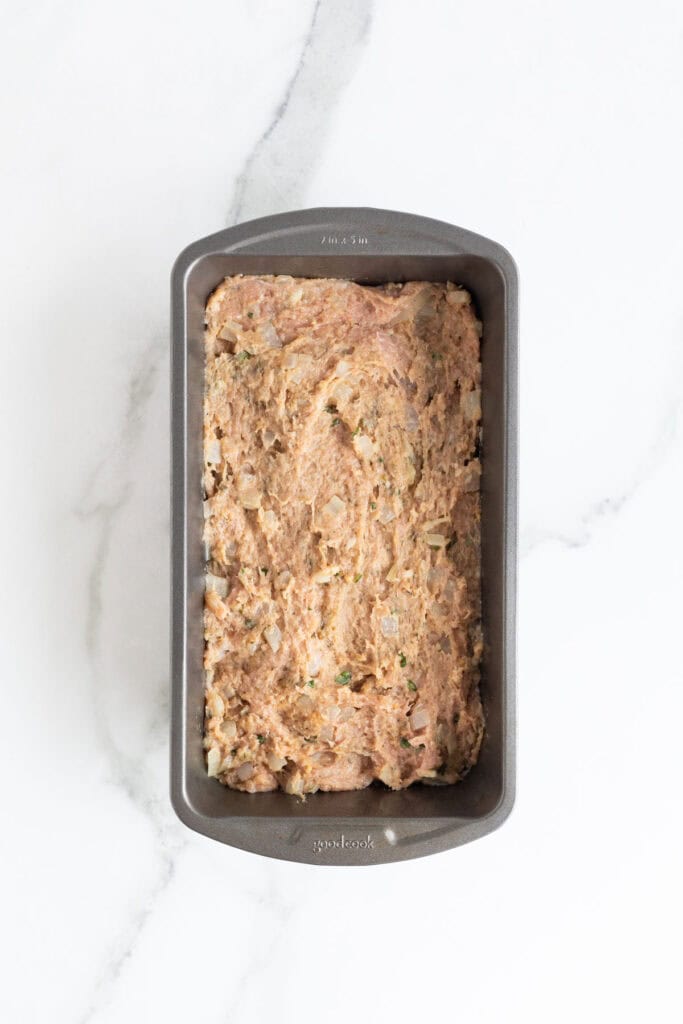 Turkey meatloaf mixture pressed into a loaf pan, ready to go into the oven