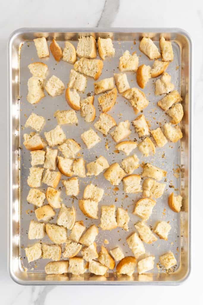 Golden brown toasted croutons on a baking sheet