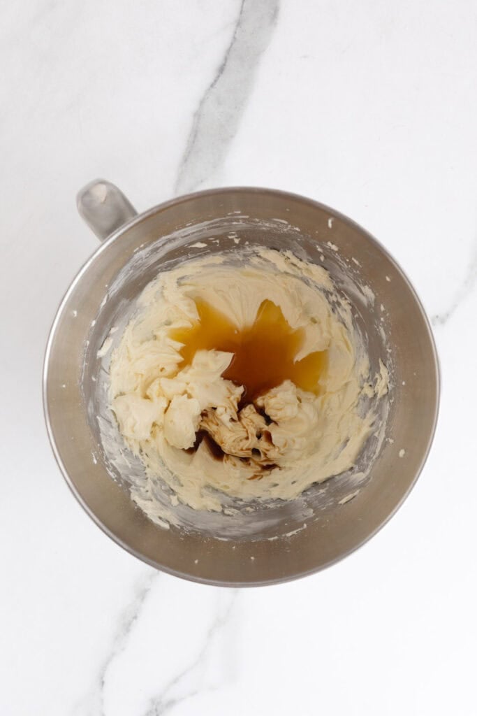 Vanilla extract and orange juice added to the bowl of whipped frosting for added flavor