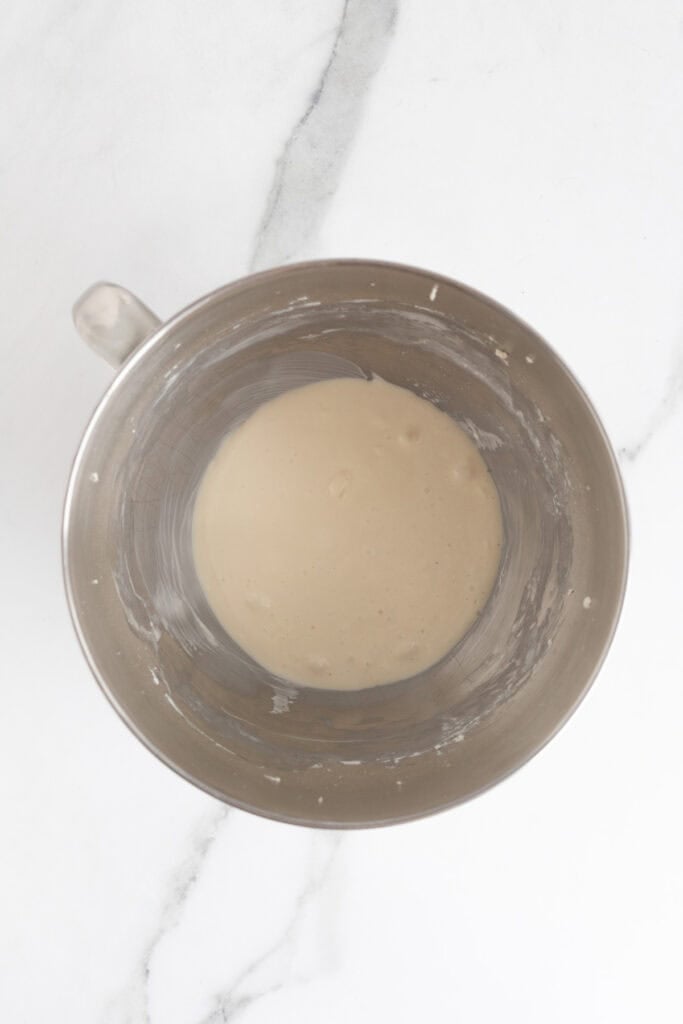 Finished frosting mixture in a metal bowl, creamy and slightly glossy